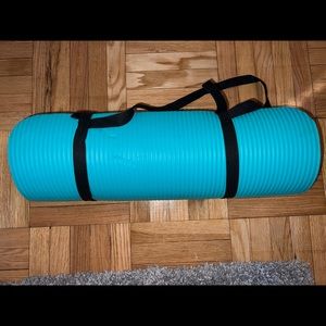 Thick turquoise yoga mat with carrying strap